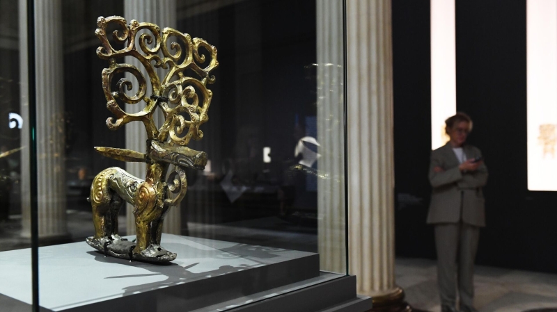 Деревянная двухплоскостная фигура оленя, окованная золотыми пластинами, на подставке, покрытой серебряными пластинами, представленная на выставке Золото сарматских вождей в Государственном музее изобразительных искусств имени А. С. Пушкина в Москве3
